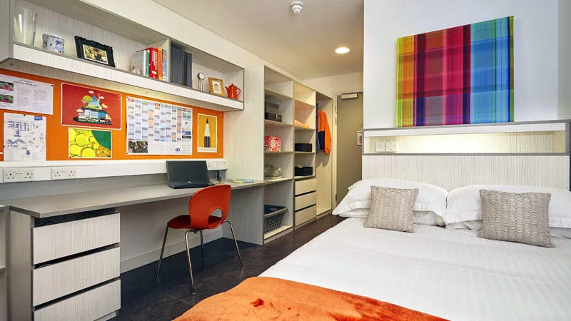 Bedroom showing desk, shelving, wardrobe and bed