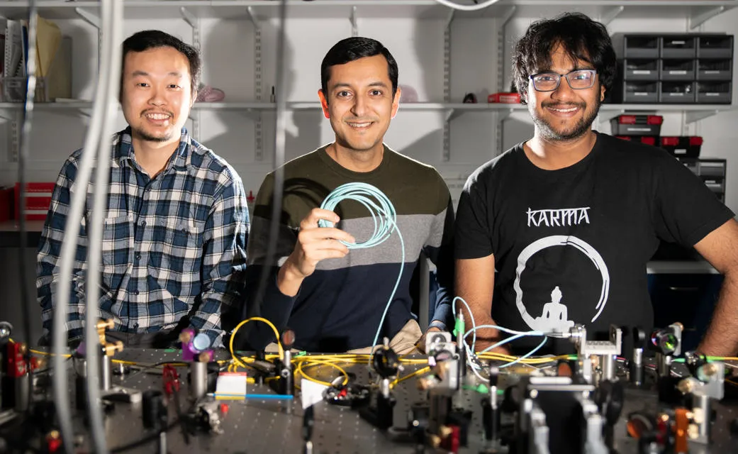 Professor Malik with members of Heriot-Watt’s Beyond Binary Quantum Information Lab (BBQLab), Dr Saroch Leedumrongwatthanakun (left) and PhD student Suraj Goel (right). Professor Malik with members of Heriot-Watt’s Beyond Binary Quantum Information Lab (BBQLab), Dr Saroch Leedumrongwatthanakun (left) and PhD student Suraj Goel (right).
