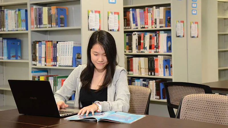 The two-storey library has been planned to cater for the different learning styles and preferences of students. Student studying in Malaysia Campus library